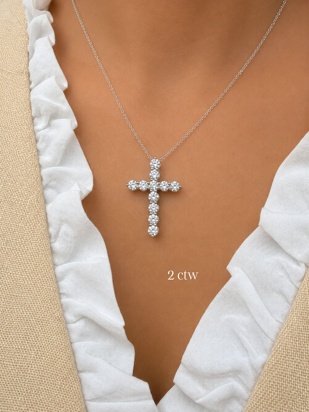 white gold 2ct diamond cross pendant necklace on a model wearing a white top.