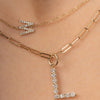 Large 14K gold initial charm on thin paperclip necklace layered with thin gold chain with small diamond initial charm
