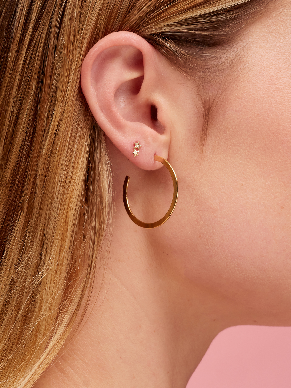 Diamond constellation earring 14K yellow gold paired with flat gold hoop on model ear