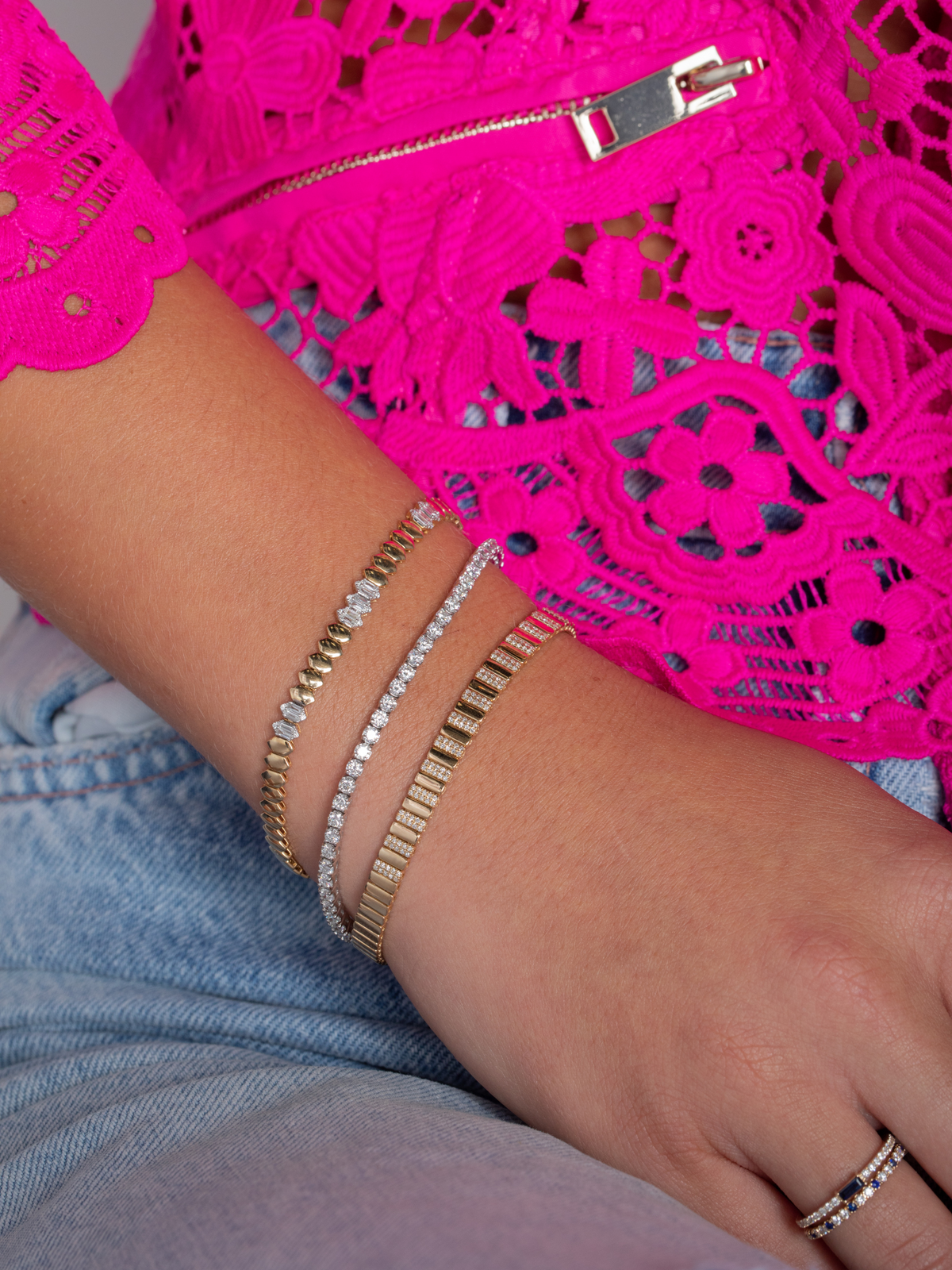 fluted skinny diamond bracelet layered with tennis bracelet and a geometric diamond gold bracelet