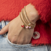 colored heart bracelet on gold beaded stretch cord
