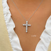 1ctw Diamond cross necklace on a person wearing a white top with beige sleeves.