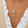 white gold 2ct diamond  cross pendant necklace  on a model wearing a white top.