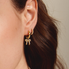 Lucy Bow Charm Huggie Earrings