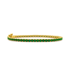 Gold bracelet with green gemstones on a white background