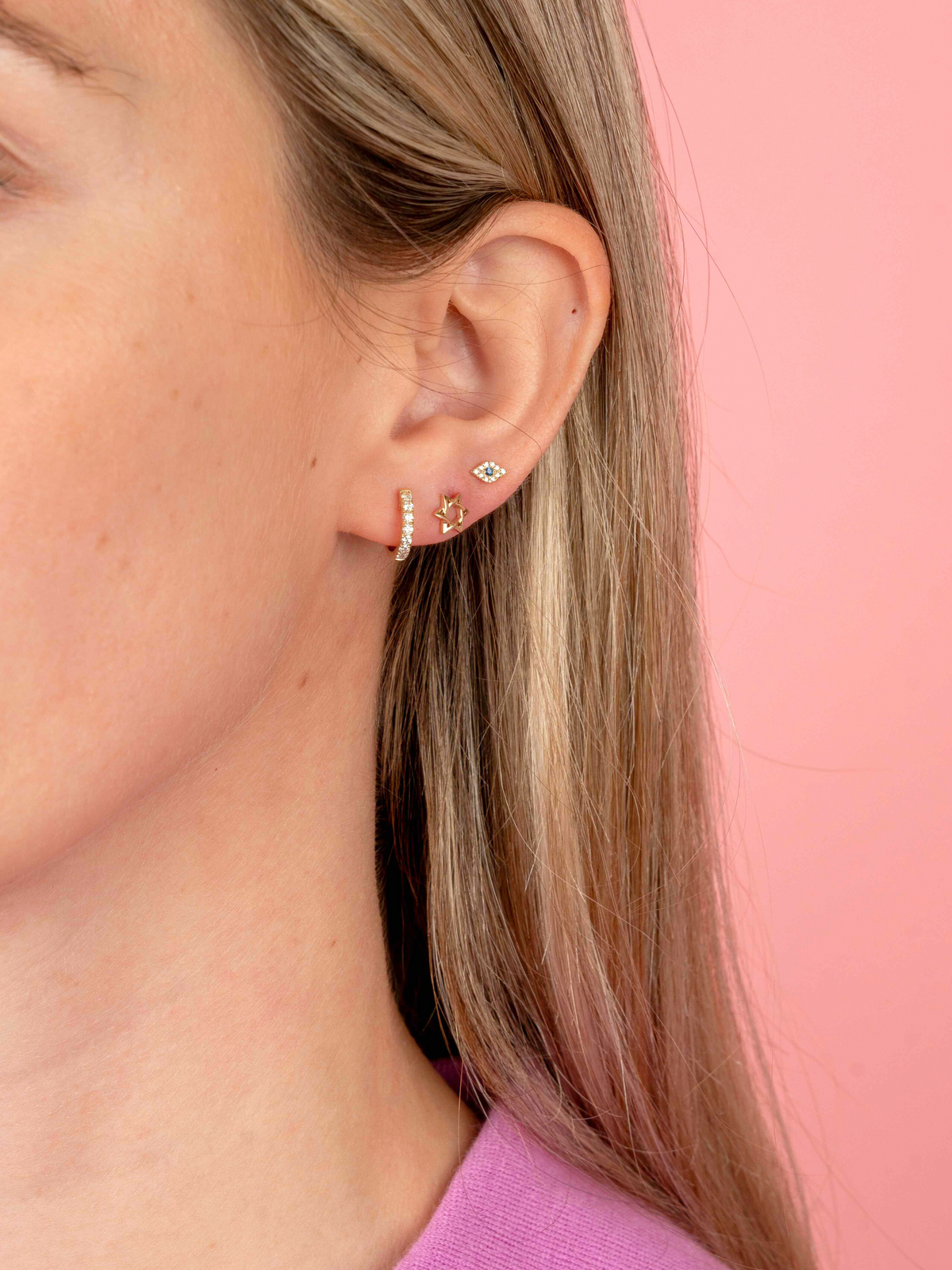 star of david earrings paired with evil eye earrings