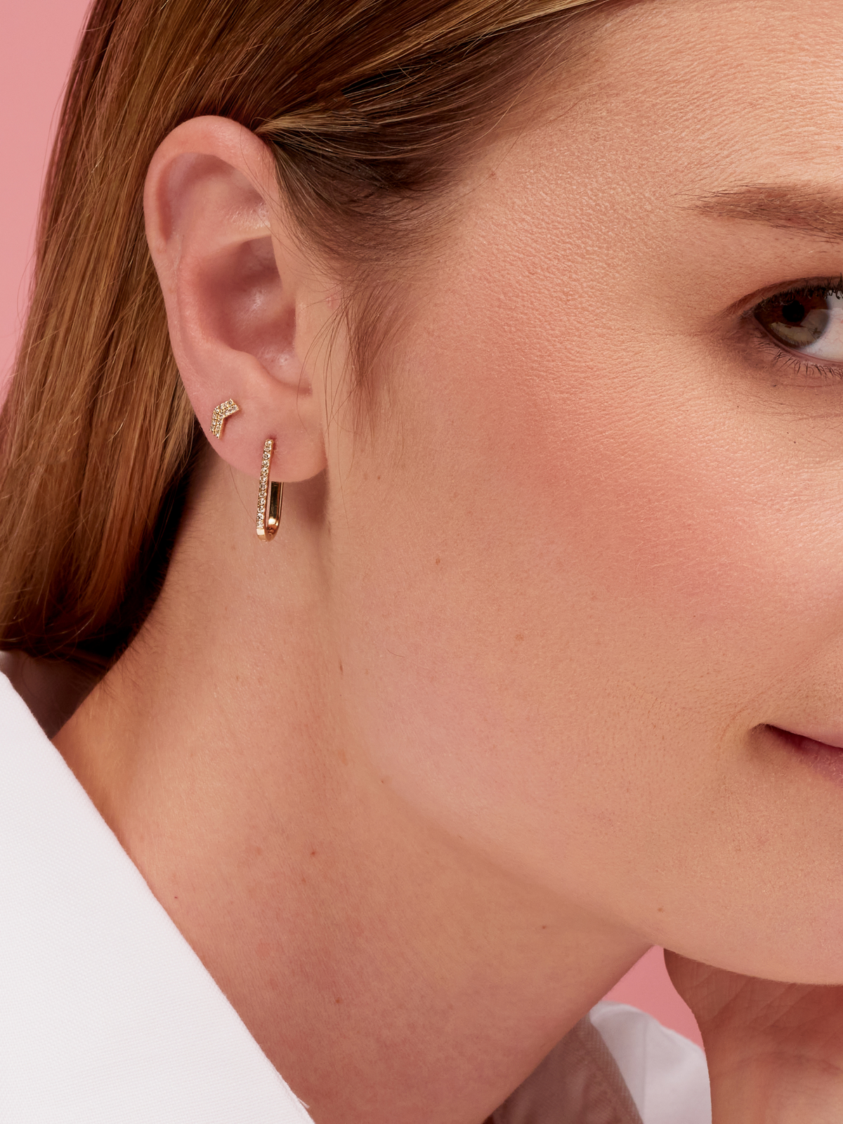 Chevron earrings paired with diamond paperclip earring on model ear