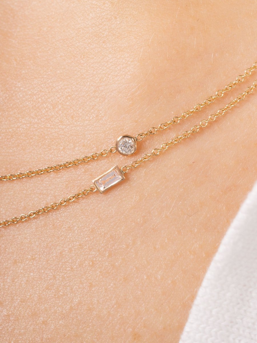 Small round diamond on gold chain and small baguette diamond on gold chain