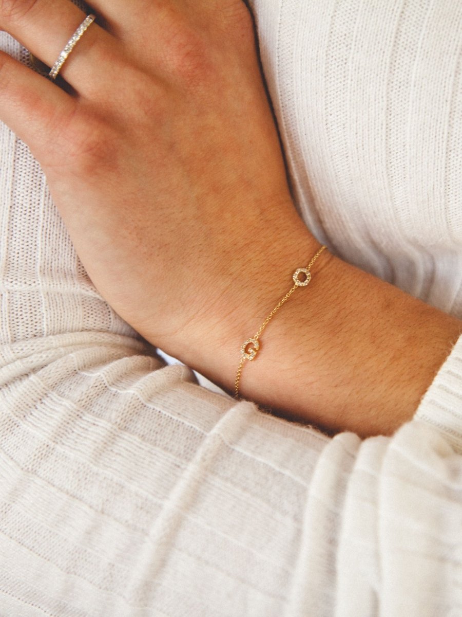 Dainty gold chain bracelet with two diamond initial charms