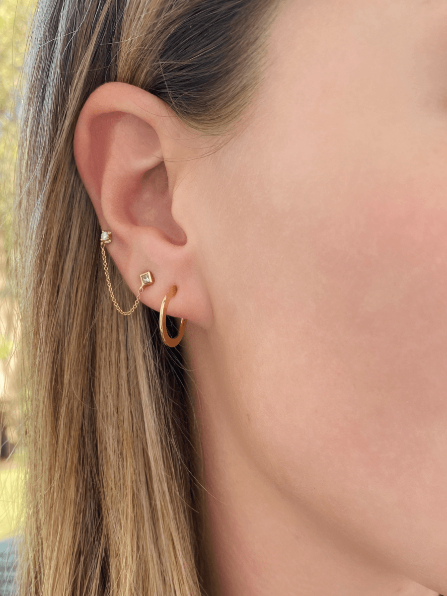 Double piercing earring with yellow gold and diamond paired with thin gold small hoop