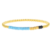 Blue, yellow, and black african vinyl and gold bead stretch bracelet on white background