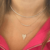 Gold diamond chain necklace layered with diamond heart necklace and diamond tennis necklace
