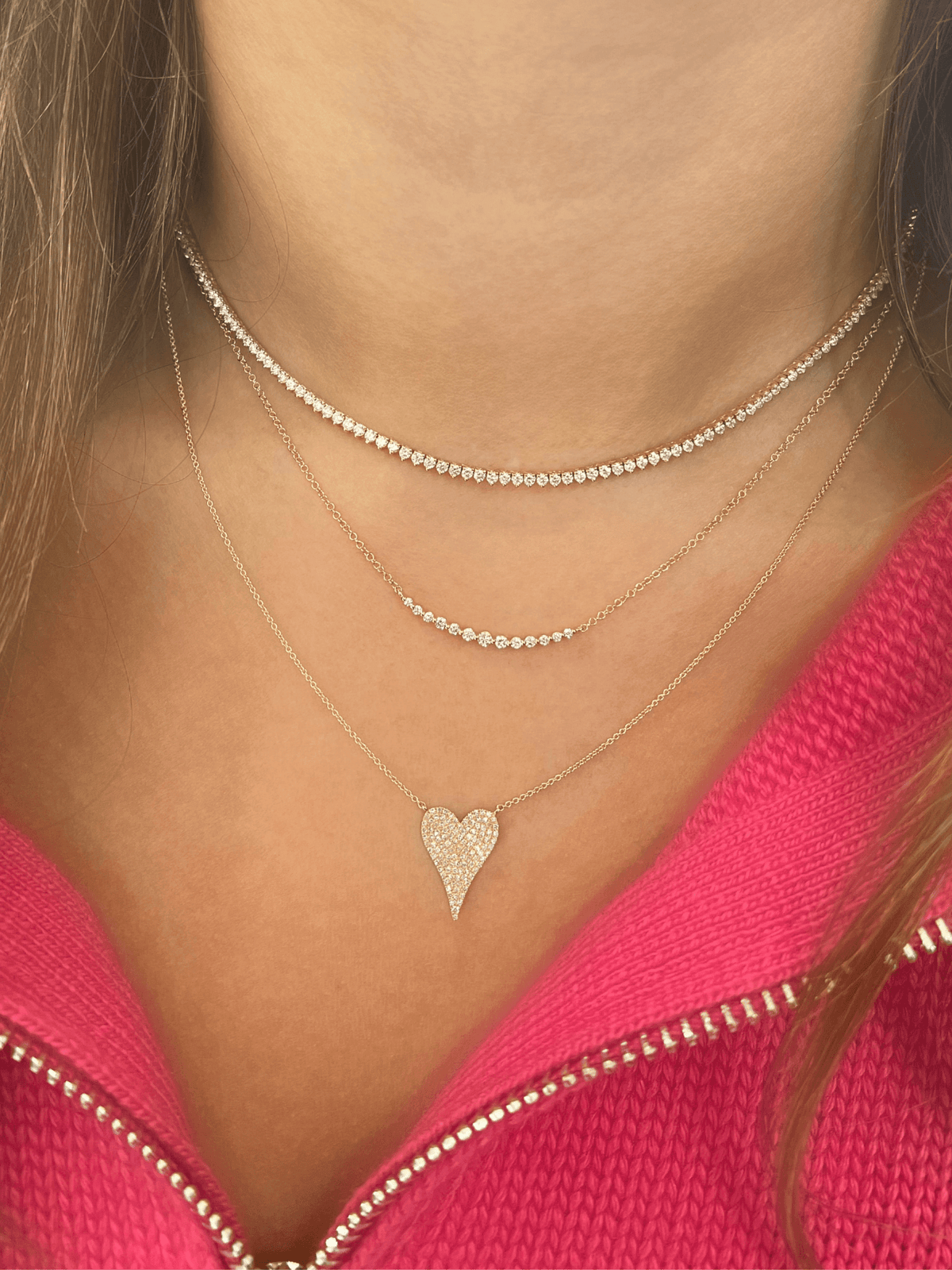 Gold diamond chain necklace layered with diamond heart necklace and diamond tennis necklace