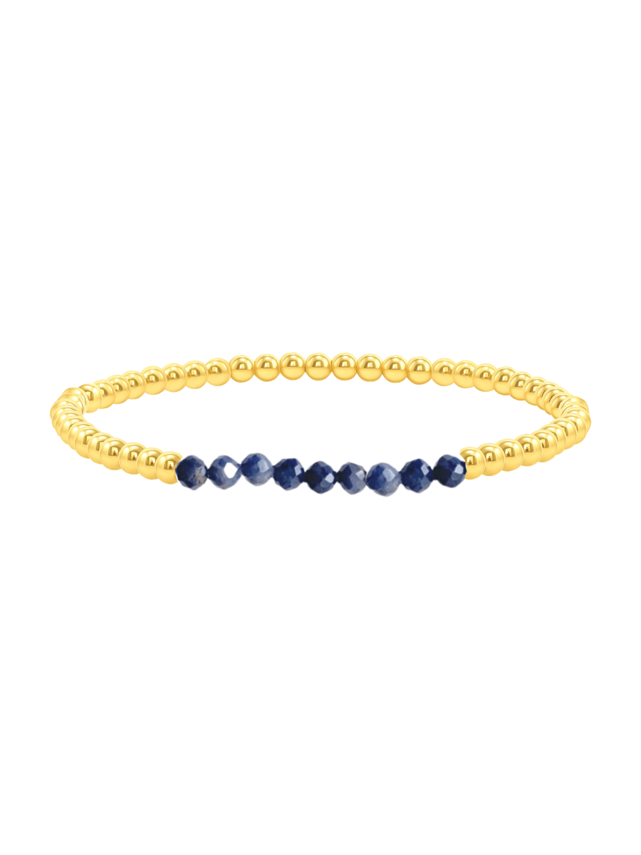 Blue sapphire and gold fill beaded bracelet on white background