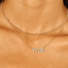 Gold choker necklace layered with diamond name necklace