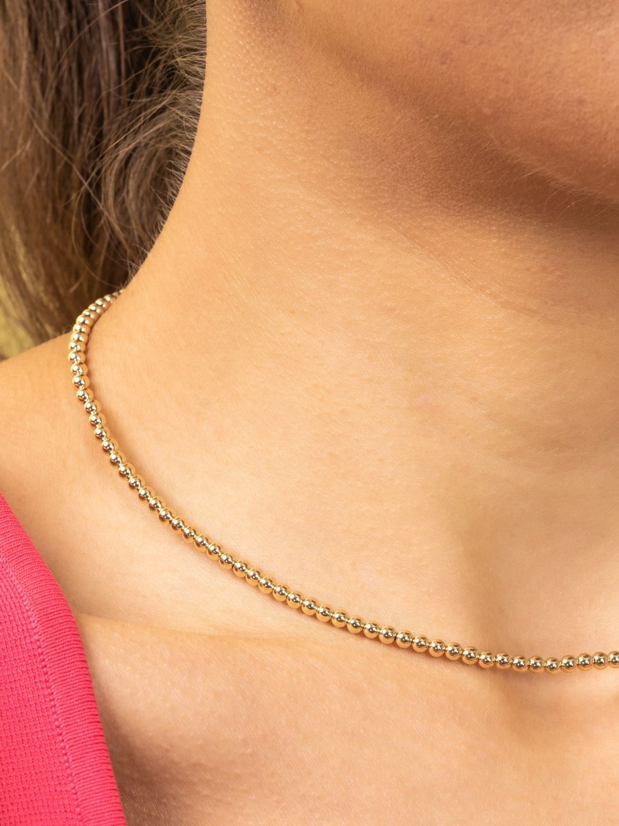 Gold bead choker necklace