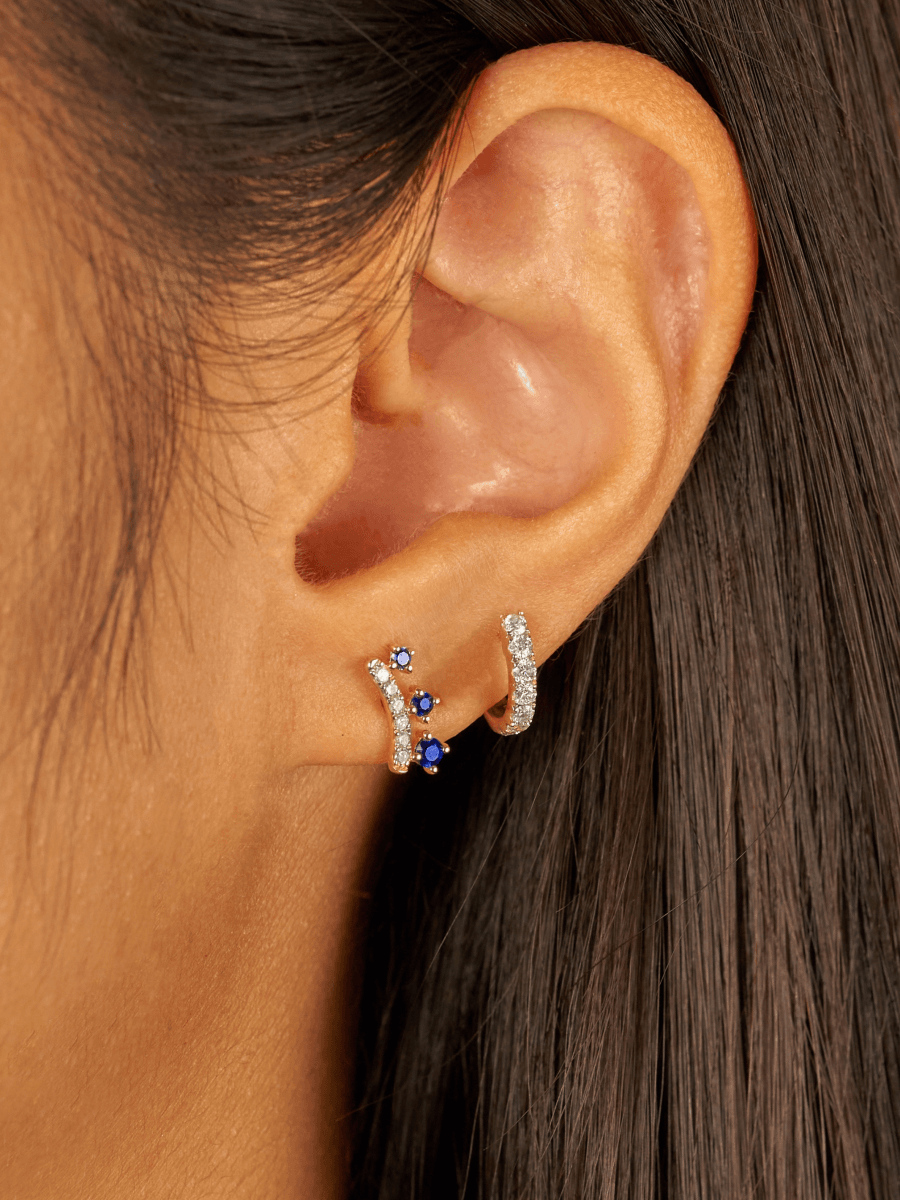 Sapphire and diamond stud earrings paired with diamond huggie