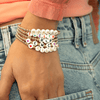 Name bracelets with gold beads on model wrist