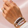 Name bracelets with gold beads on model wrist