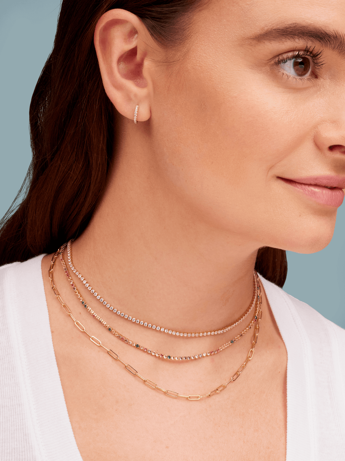 Gold CZ diamond tennis choker layered with gold paperclip necklace and rainbow CZ tennis choker