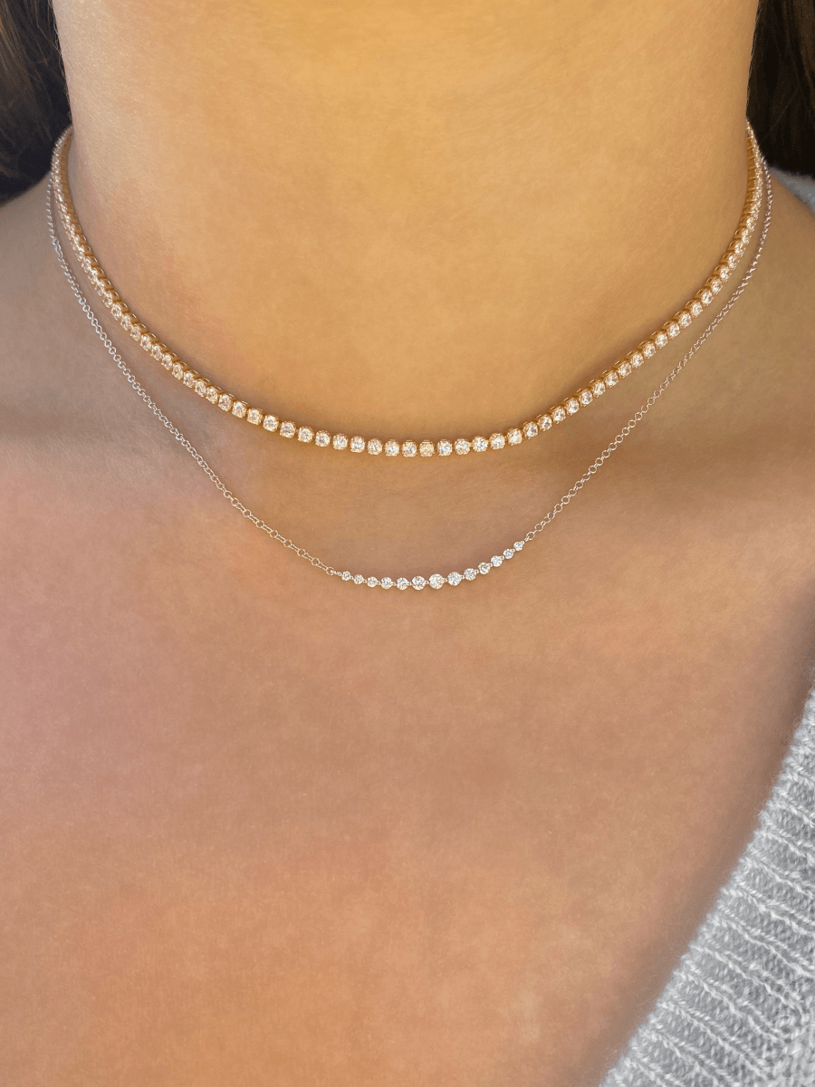 Gold CZ tennis necklace layered with chasing diamond necklace in white gold