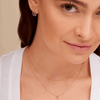 Dainty gold chain link necklace layered with diamond initial necklace