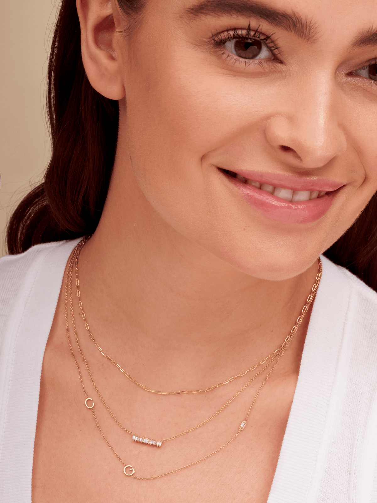 Dainty gold chain necklace layered with diamond baguette bar necklace and gold initial necklace with diamond baguette
