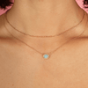 Dainty gold chain link necklace layered with opal and diamond necklace