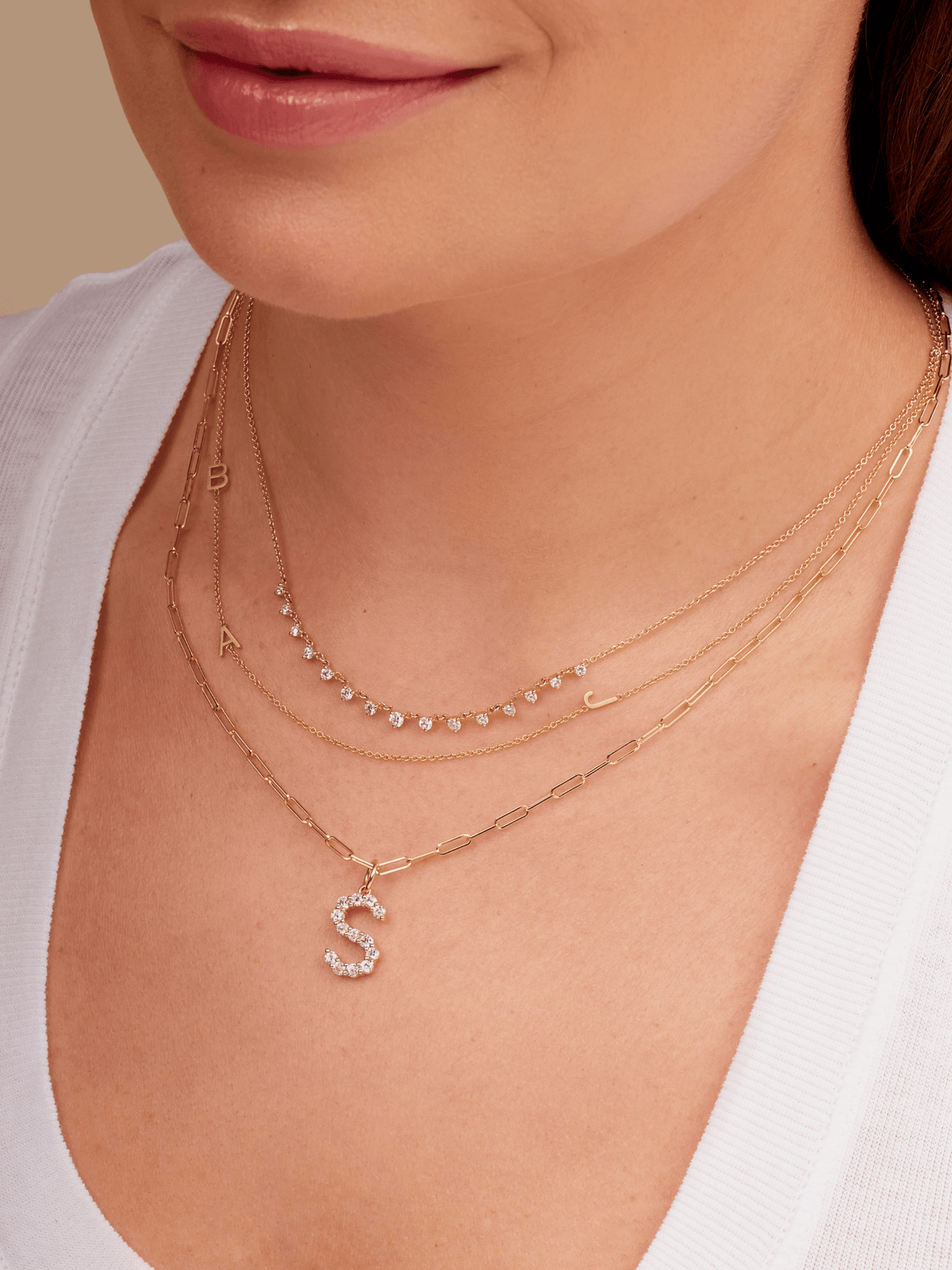 14K gold large diamond initial charm on dainty gold paperclip necklace layered with diamond layering necklace and gold charm initial necklace