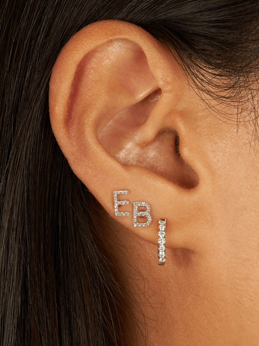 Ear stack with two diamond initial studs and diamond huggie