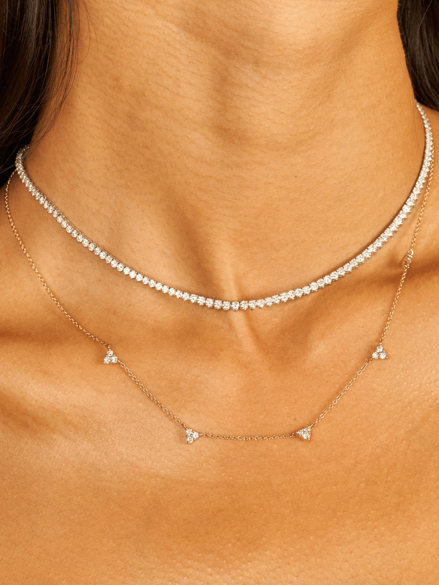 14K white gold diamond tennis necklace layered with diamond trio layering necklace