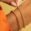 Everyday gold beaded bracelets on model wrist