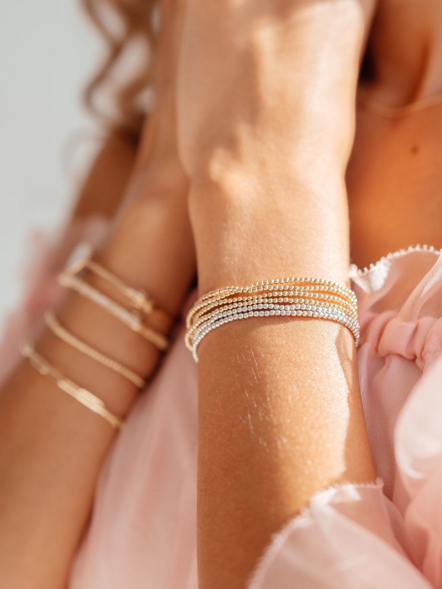 2mm silver and gold stretch bracelets on model wrist