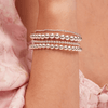 Small beaded stretch bracelets in silver on model wrist