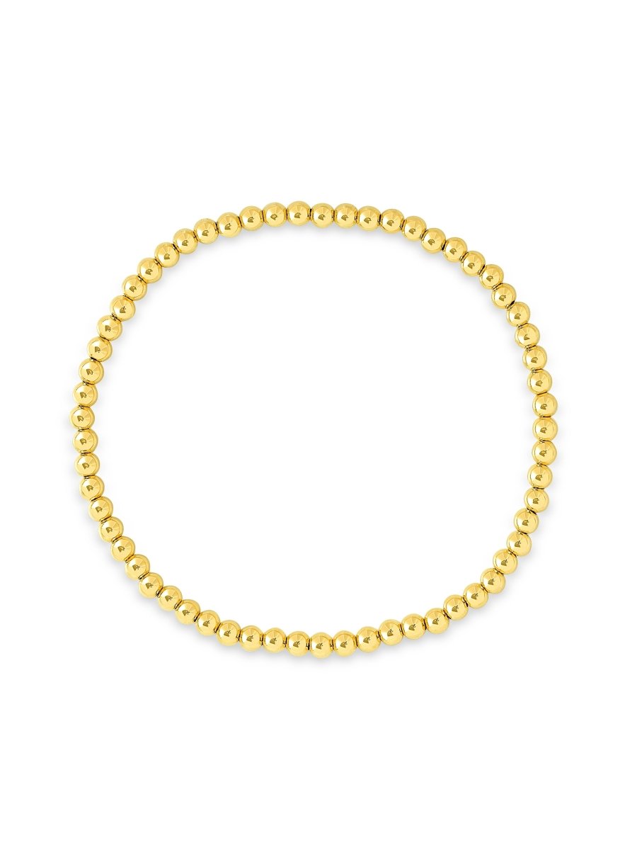 Gold bead stretch bracelet on white background