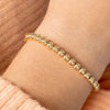 Yellow gold beaded stretch bracelet on model wrist