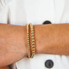 Gold beaded bracelet set 5mm and 6mm on model wrist