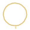 Gold beaded stretch bracelet with cross charm on white background
