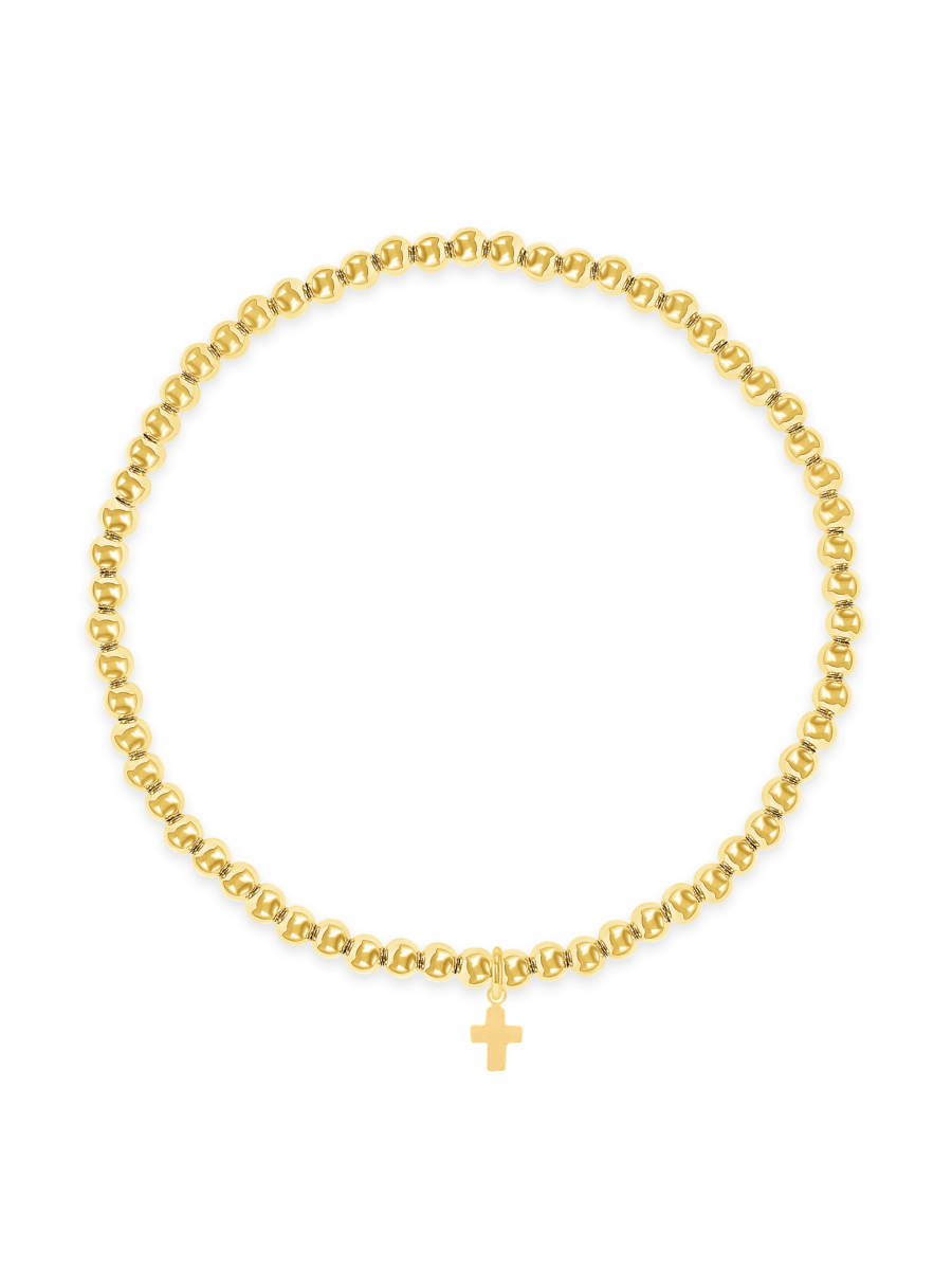 Gold beaded stretch bracelet with cross charm on white background