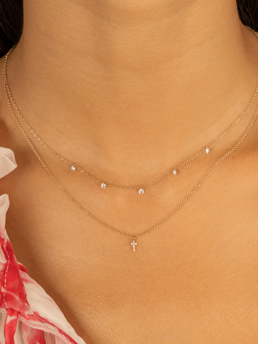 5 in 1 diamond necklace layered with diamond cross necklace
