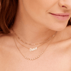 14K gold script name necklace layered with gold paperclip chain necklace and graduated diamond layering necklace