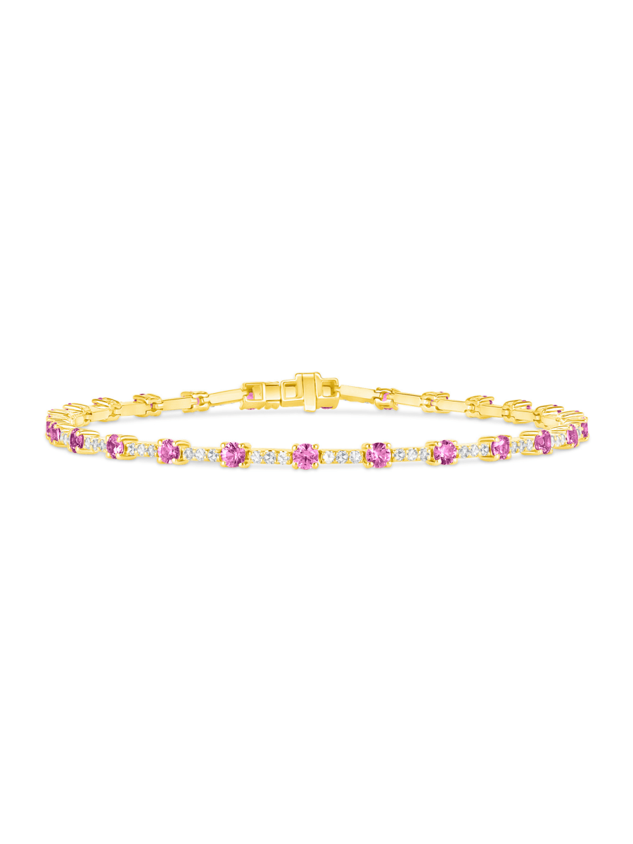Pink sapphire and diamond tennis bracelet in 14K yellow gold on white background