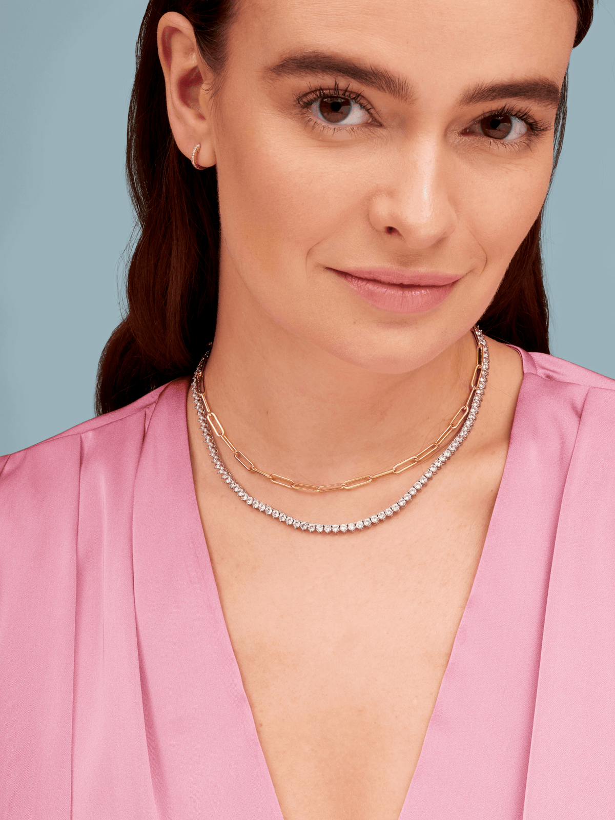 Silver graduated cz choker layered with gold paperclip necklace
