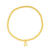 Initial bracelet with gold beads and gold charm on white background