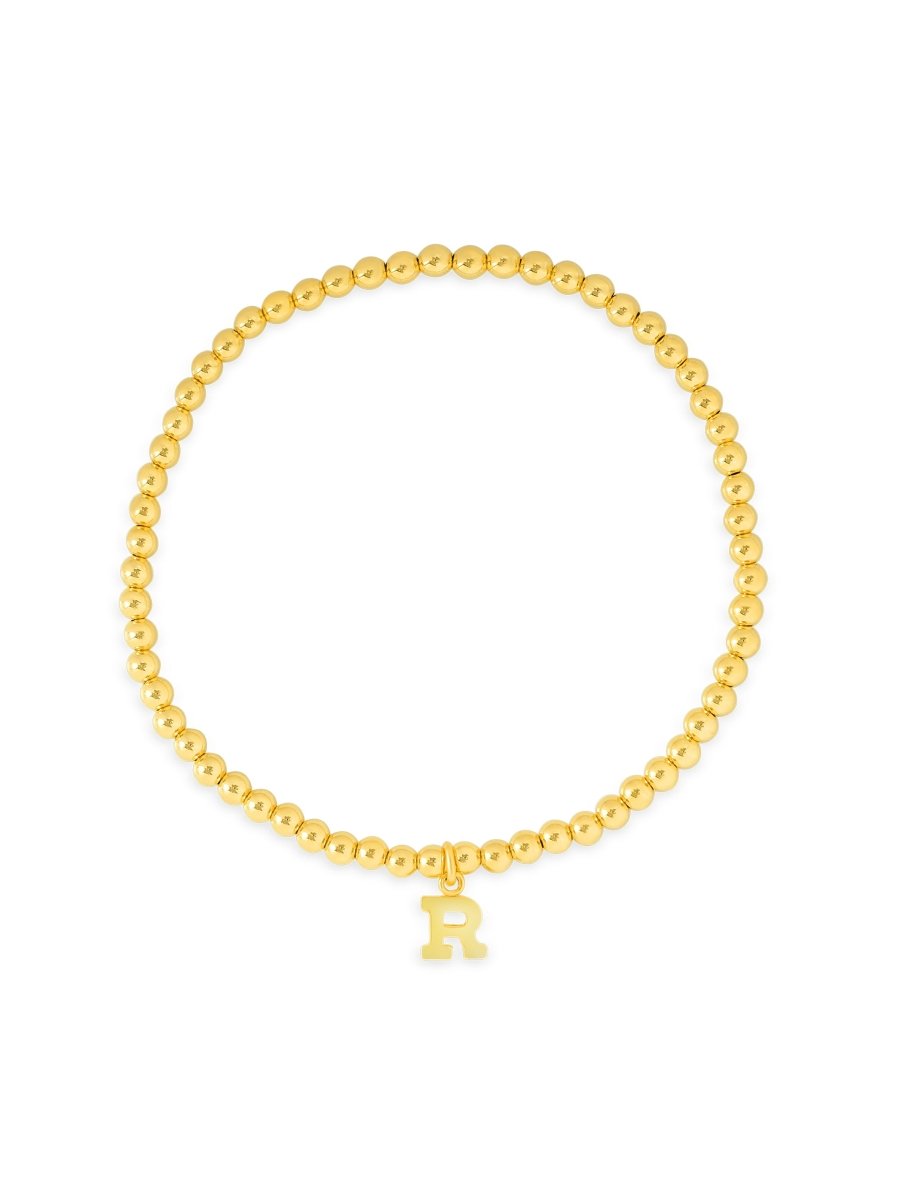 Initial bracelet with gold beads and gold charm on white background