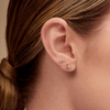 Gold star earring paired with star trio stud on model ear