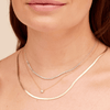 Diamond tennis chain necklace in 14K white gold layered with herringbone snake gold chain necklace and thin gold chain with single diamond