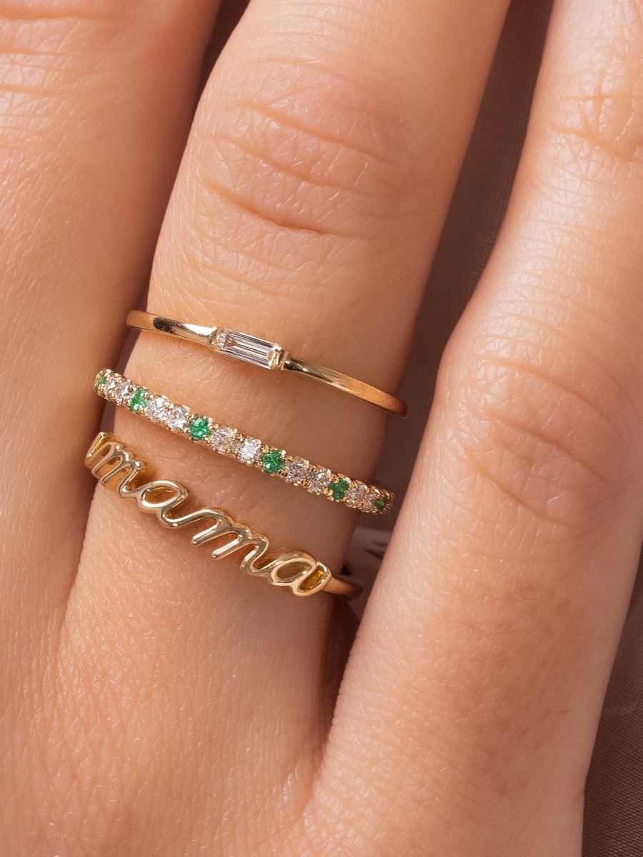 14K yellow gold mama script ring layered with thin gold band with diamond baguette and alternating emerald and diamond gold band