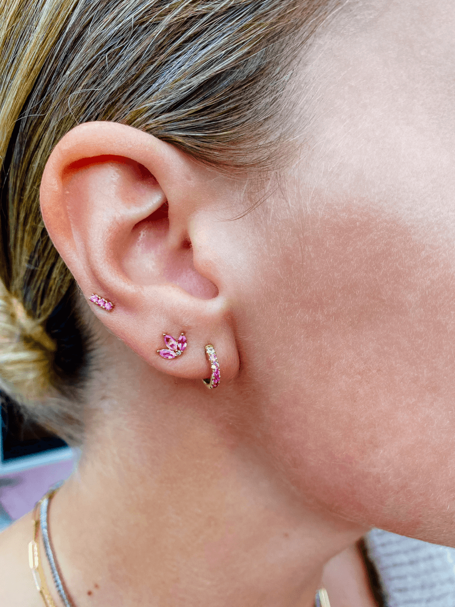 Pink ombre huggie paired with pink sapphire lotus stud and pink sapphire bar stud on model ear