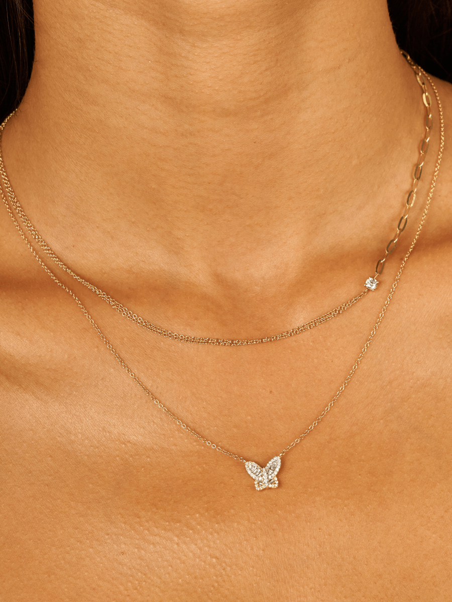 Gold chain diamond necklace layered with diamond butterfly necklace